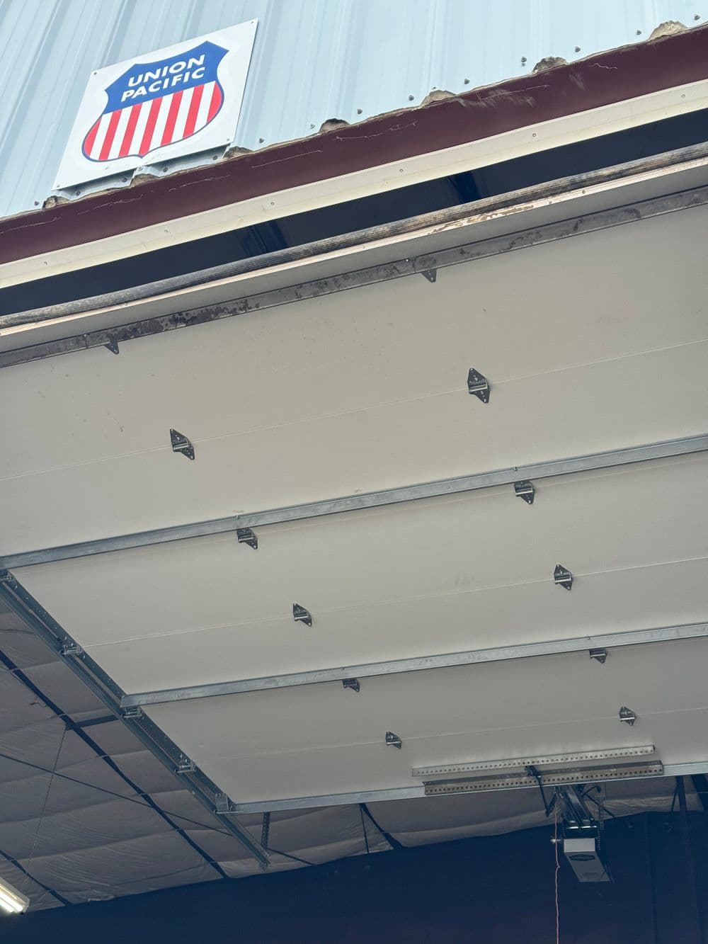 Union Pacific logo on a building's overhead garage door with metal reinforcements.
